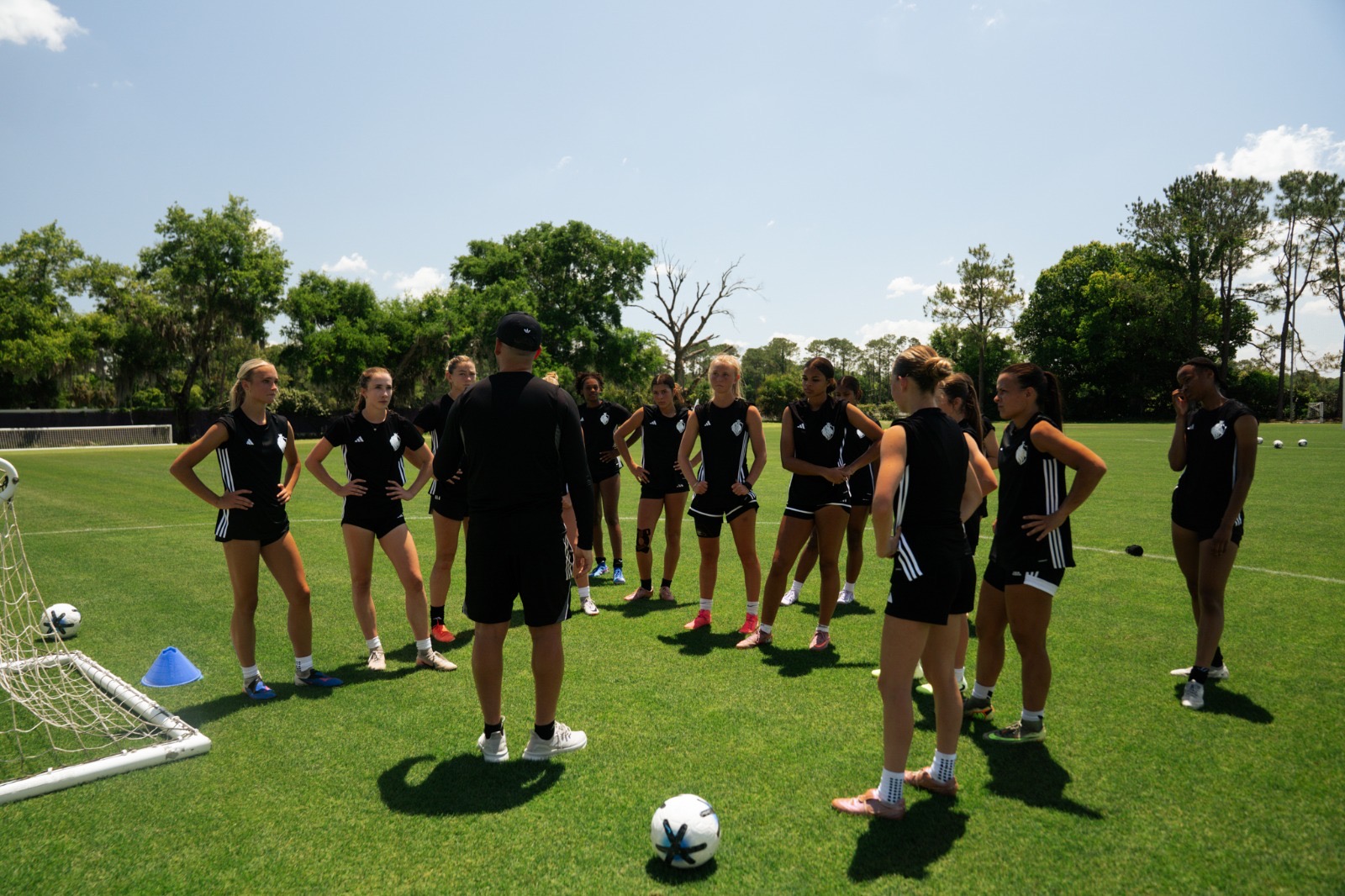 Players listening to a coach at training